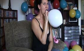 Brunette mature blowing balloons