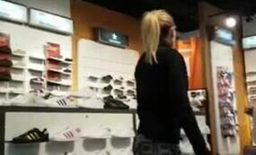 Girl in leggings at the shoe shop
